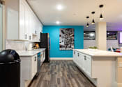Thumbnail 79 of 106 - a kitchen with white cabinets and a blue wall
