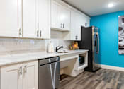 Thumbnail 78 of 106 - a kitchen with white cabinets and a stainless steel refrigerator