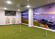 Thumbnail 74 of 106 - a putting green in a room with a view of the ocean