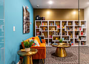 Thumbnail 57 of 106 - a living room with a couch and tables and a bookshelf