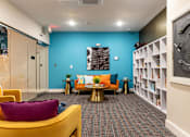 Thumbnail 55 of 106 - a living room with a blue wall and yellow furniture