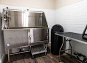 Thumbnail 53 of 106 - a kitchen with a large stainless steel refrigerator and a table