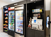 Thumbnail 49 of 106 - a refrigerator and a coffee machine in a store