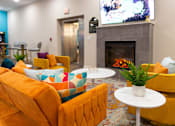 Thumbnail 60 of 106 - a living room with couches and chairs and a fireplace