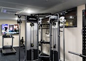 Thumbnail 71 of 106 - a fitness room with exercise equipment in a home gym