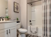 Thumbnail 10 of 33 - A bathroom with a toilet, sink, and shower.