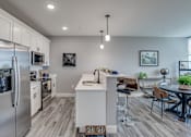 Thumbnail 22 of 33 - an open kitchen and dining area with stainless steel appliances and a table and chairs