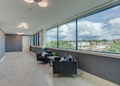Thumbnail 16 of 33 - a lobby with couches and a window with a view of a city