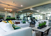 Thumbnail 75 of 84 - A modern living room with a white sofa and a glass wall.