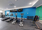 Thumbnail 78 of 84 - A gym with a variety of exercise equipment.