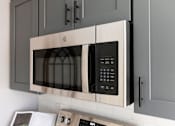 Thumbnail 26 of 53 - A modern stainless steel microwave oven with digital display and control panel.