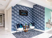 Thumbnail 18 of 50 - A wall with a pattern of blue hexagons with a black sign on it.