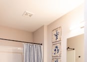 Thumbnail 17 of 50 - A bathroom with a toilet, sink, and shower.