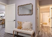 Thumbnail 40 of 50 - A white door with a mirror above it and a bench with a pillow on it.