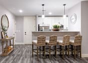 Thumbnail 43 of 50 - A kitchen with a dining table and chairs.