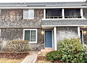 Thumbnail 40 of 53 - A house with a grey siding and a blue door.
