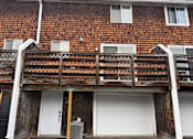 Thumbnail 41 of 53 - A white garage door is on the ground floor of a house.