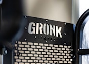 Thumbnail 2 of 24 - A close up of a black and white machine with the word GRONK on it.