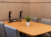 Thumbnail 51 of 57 - A conference table with chairs and a plant on top.
