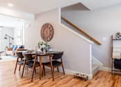 Thumbnail 9 of 57 - A dining room with a wooden table and chairs.