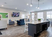 Thumbnail 12 of 24 - A reception area with a white counter and blue chairs.