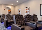 Thumbnail 7 of 24 - A row of black leather recliner chairs are lined up in a row.