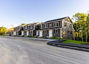 Thumbnail 10 of 60 - A row of houses with a road in front of them.