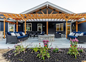 Thumbnail 58 of 60 - A patio with a pergola and outdoor furniture.
