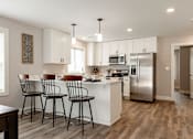 Thumbnail 28 of 60 - A kitchen with white cabinets and a refrigerator.