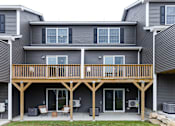 Thumbnail 64 of 64 - A grey house with a wooden balcony.