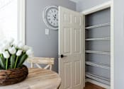 Thumbnail 12 of 53 - A white door is open to a hallway with shelves.