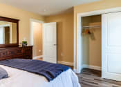 Thumbnail 31 of 34 - a bedroom with a bed and a closet and a mirror