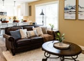 Thumbnail 4 of 34 - a living room with a couch and a table
