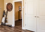 Thumbnail 18 of 34 - a room with white doors and a hallway with a clock on the wall and a