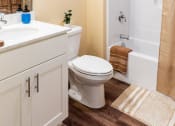 Thumbnail 32 of 34 - a bathroom with a shower and a sink and a toilet