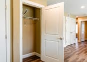 Thumbnail 17 of 34 - a walk in closet with a white door and a closet hanger
