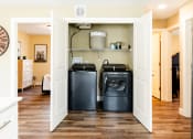 Thumbnail 19 of 34 - a laundry room with two washes and a dryer in it