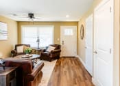 Thumbnail 5 of 34 - a living room with leather furniture and a ceiling fan