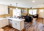 Thumbnail 9 of 34 - a kitchen with an island and a living room with a couch