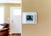 Thumbnail 20 of 34 - an image of a thermostat on a wall in a living room