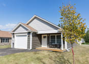 Thumbnail 1 of 34 - the front of a white and gray house with a tree