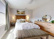 Thumbnail 68 of 71 - A well-lit bedroom with a large bed and a window with blinds.