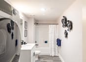 Thumbnail 106 of 106 - A bathroom with a white sink and a white toilet.
