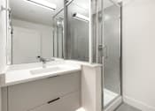 Thumbnail 3 of 5 - A white bathroom vanity with a sink and mirror.