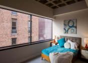 Thumbnail 5 of 8 - a bedroom with a bed and a large window