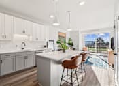 Thumbnail 61 of 99 - A kitchen with white cabinets and a white island with brown chairs.