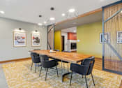 Thumbnail 24 of 99 - A conference room with a long table and chairs.