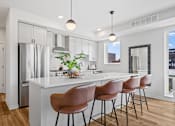 Thumbnail 1 of 99 - a kitchen with a large island with bar stools