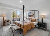 Thumbnail 9 of 103 - a bedroom with a bed and a large window