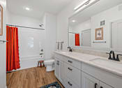 Thumbnail 106 of 113 - A bathroom with a white sink and a white toilet.